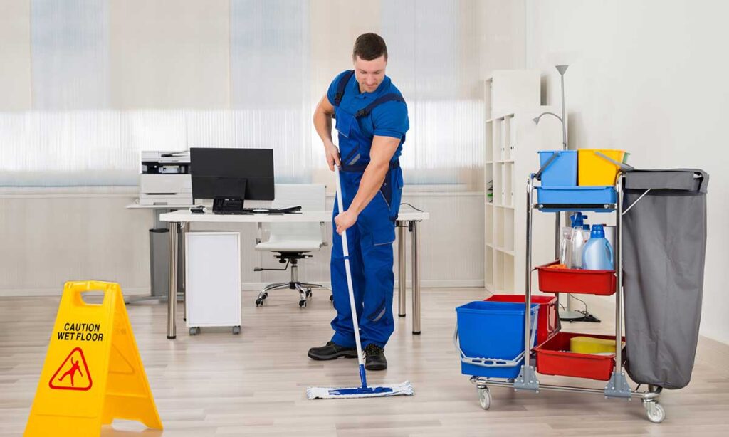 Men moping the floor in office